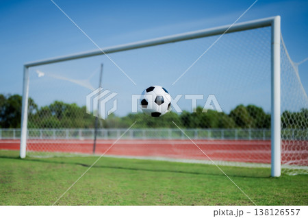 Footballs on the field and goal nets in a large stadium Footballs on the field and goal nets in a large stadium 138126557
