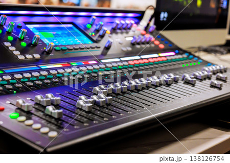 Recording studio features large mixing console with numerous controls, buttons during recording studio sound Recording studio features large mixing console with numerous controls, buttons during recording studio sound 138126754
