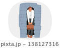 Depressed business man stands in narrow stone doorway symbolizing pressure of circumstances 138127316