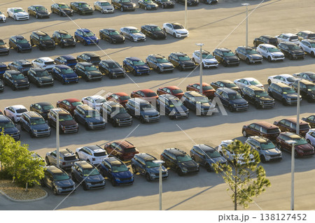 Large parking lot of local dealer with many brand new cars parked for sale. Development of american automotive industry and distribution of manufactured vehicles concept 138127452