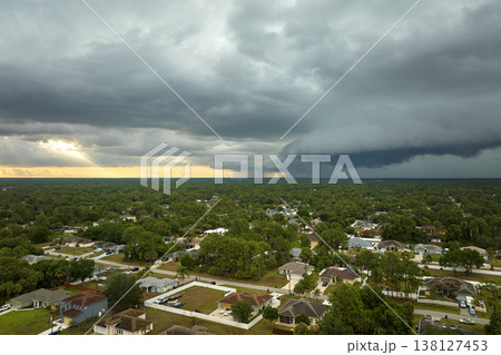 Landscape of dark ominous clouds forming on stormy sky before heavy thunderstorm over rural town area Landscape of dark ominous clouds forming on stormy sky before heavy thunderstorm over rural town area 138127453