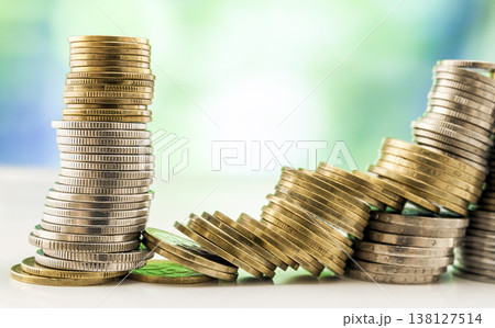 Growing coins stacks with green and blue sparkling bokeh background. Financial growth, saving money, business finance wealth and success concept. Growing coins stacks with green and blue sparkling bokeh background. Financial growth, saving money, business finance wealth and success concept. 138127514