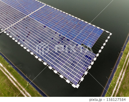 Floating solar photovoltaic panels at sustainable electrical power plant for generating clean electric energy. Concept of renewable electricity with zero emission on water surface Floating solar photovoltaic panels at sustainable electrical power plant for generating clean electric energy. Concept of renewable electricity with zero emission on water surface 138127584