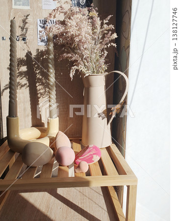 Beauty sponges and blenders on a wooden shelf with twisted candles and pampas grass. Warm aesthetic morning sunlight Beauty sponges and blenders on a wooden shelf with twisted candles and pampas grass. Warm aesthetic morning sunlight 138127746