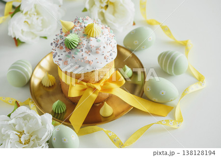 Easter Cake Decorated Yellow Ribbon with Flowers and Pastel Eggs on White Background Easter Cake Decorated Yellow Ribbon with Flowers and Pastel Eggs on White Background 138128194