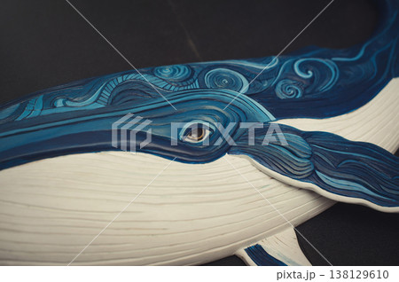 Close-up of a carved wooden whale showing intricate blue textures and an eye detail. Close-up of a carved wooden whale showing intricate blue textures and an eye detail. 138129610