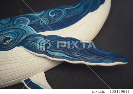 Close-up detail of a hand-painted wooden whale sculpture, focusing on the fin and intricate carved patterns. Close-up detail of a hand-painted wooden whale sculpture, focusing on the fin and intricate carved patterns. 138129611