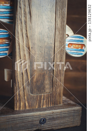 Close-up of a rustic wooden lamp base showing natural timber grain, carved recessed panel, and a power socket. 138129632