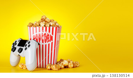 Popcorn and gamepad on yellow background 138130514