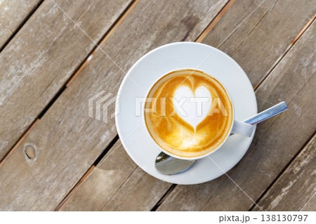 Cappuccino with heart foam on wooden table 138130797