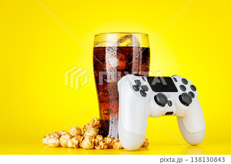 Popcorn, cola and gamepad on yellow background Popcorn, cola and gamepad on yellow background 138130843