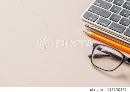 Office supplies on beige desk 138130851