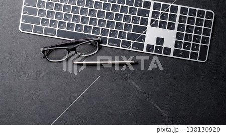 Office supplies on dark leather desk 138130920