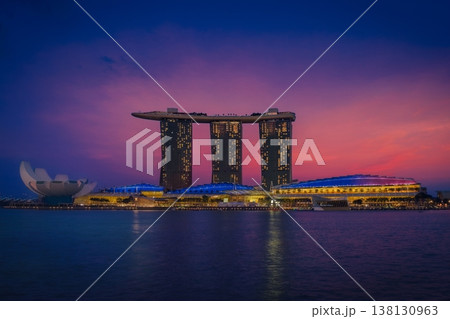 Marina Bay Sands in Singapore during sunset with a vibrant pink sky reflecting over the modern skyline. Marina Bay Sands in Singapore during sunset with a vibrant pink sky reflecting over the modern skyline. 138130963