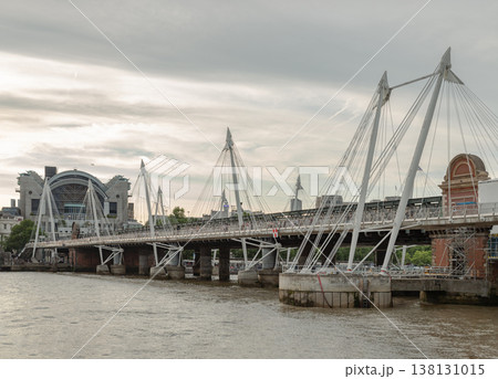 A striking architectural dialogue unfolds across the River Thames, where the industrial legacy of the Hungerford Bridge meets the modern elegance of the Golden Jubilee Footbridges. A striking architectural dialogue unfolds across the River Thames, where the industrial legacy of the Hungerford Bridge meets the modern elegance of the Golden Jubilee Footbridges. 138131015