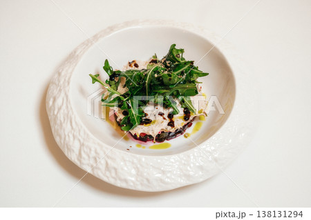 Arugula Salad With Burrata Cheese, Balsamic Drizzle, Olive Oil, Cracked Pepper On Textured White 138131294