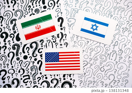 Three cards showing flags of IRAN, ISRAEL, and USA rest on background of hand drawn question marks. USA Israel Iran, Middle East crisis, trilateral relations, International security. Three cards showing flags of IRAN, ISRAEL, and USA rest on background of hand drawn question marks. USA Israel Iran, Middle East crisis, trilateral relations, International security. 138131348