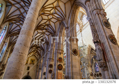 Interior view of Ulm Cathedral in Germany. Features ornate ceiling, detailed stone carvings, and stained glass windows. Gothic architecture highlights 138132076