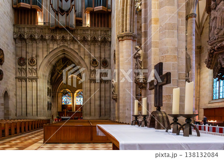 Interior view of Ulm Cathedral in Germany. Features ornate ceiling, detailed stone carvings, and stained glass windows. Gothic architecture highlights 138132084