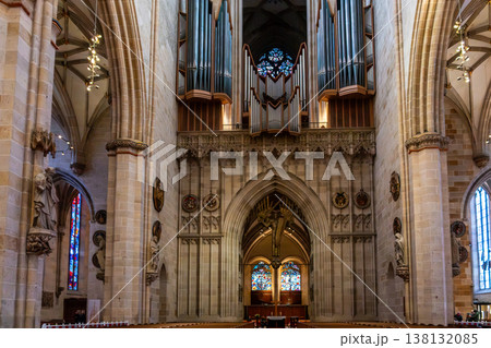 Interior view of Ulm Cathedral in Germany. Features ornate ceiling, detailed stone carvings, and stained glass windows. Gothic architecture highlights 138132085