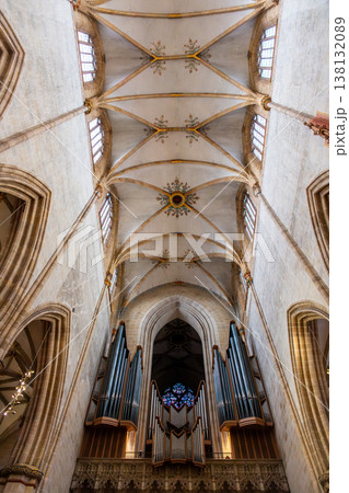 Interior view of Ulm Cathedral in Germany. Features ornate ceiling, detailed stone carvings, and stained glass windows. Gothic architecture highlights 138132089