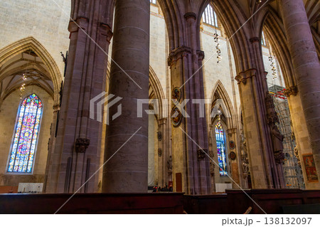 Interior view of Ulm Cathedral in Germany. Features ornate ceiling, detailed stone carvings, and stained glass windows. Gothic architecture highlights 138132097