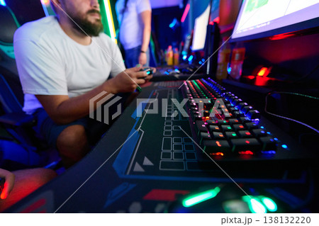 Friends Gaming Together at RGB PC Setup With Mechanical Keyboard and Game Controller in LAN Cafe Friends Gaming Together at RGB PC Setup With Mechanical Keyboard and Game Controller in LAN Cafe 138132220