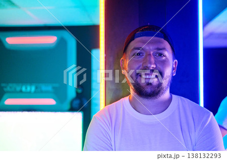 Smiling Young Man In Neon Portrait At Gaming Lounge With Colorful LED Lights 138132293