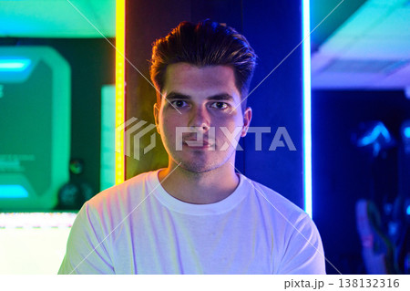 Young Man Portrait in Neon Lights With Confident Expression and Modern Gaming Studio Vibe 138132316