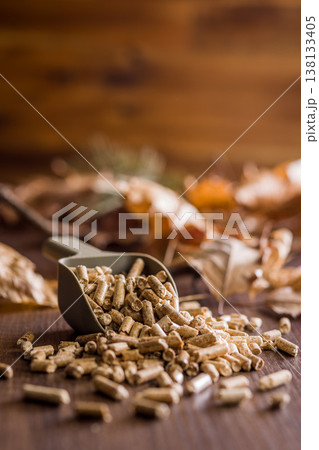 Scoop of Wood Pellets Spilled on Table for Biomass Fuel and Home Heating Sustainable Energy 138133405