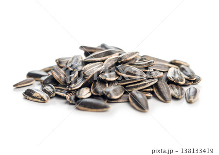 Pile of Sunflower Seeds Close-Up on White Background. Roasted Snack and Oilseed Texture Pile of Sunflower Seeds Close-Up on White Background. Roasted Snack and Oilseed Texture 138133419