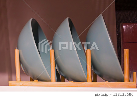 Ceramic bowls drying on rack 138133596