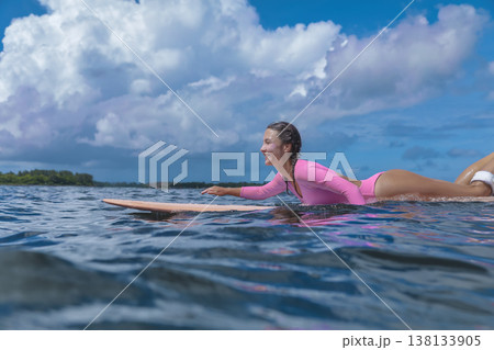 Woman Practicing Accurate Surfing Skills In Peaceful Seaside Environment Woman Practicing Accurate Surfing Skills In Peaceful Seaside Environment 138133905