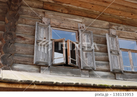 Vintage wooden window showcasing weathered shutters and reflections Vintage wooden window showcasing weathered shutters and reflections 138133953