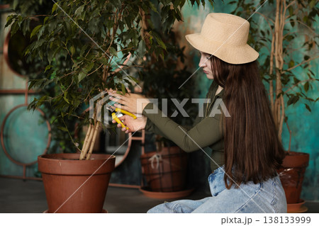 Caucasian woman demonstrating pruning technique with shears 138133999