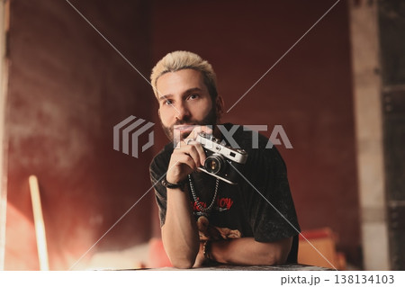 Confident white content creator testing camera gear in studio 138134103