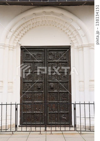 Intricate carved relief panels adorn majestic arch entrance 138134151
