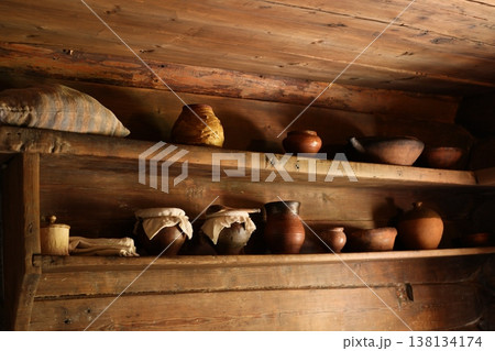 Aged pottery paired with rustic wooden shelving environment Aged pottery paired with rustic wooden shelving environment 138134174