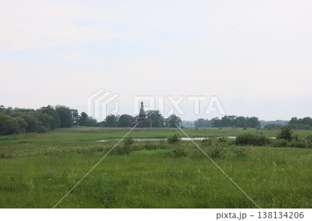 Serene rural scene with solitary spire and reflective waters Serene rural scene with solitary spire and reflective waters 138134206