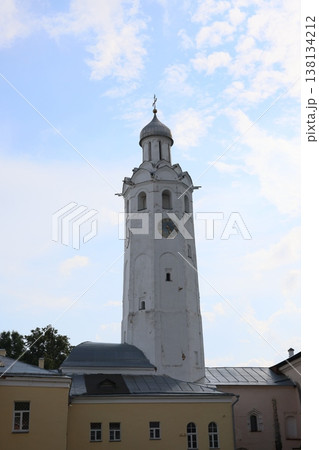 Bright sky celebration. Sunny bell tower with festive surroundings Bright sky celebration. Sunny bell tower with festive surroundings 138134212