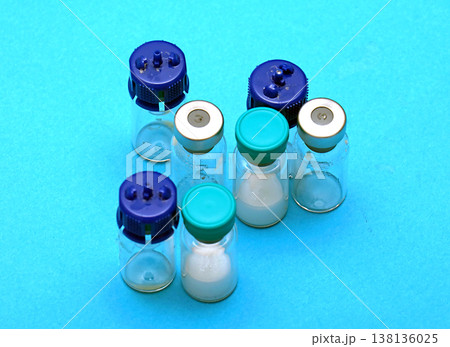 Medicine glass vials on blue background Medicine glass vials on blue background 138136025