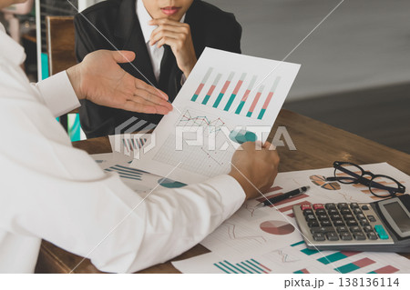 Teamwork discussing meeting point to discuss the graph up and down financial of marketing economy on desk. Teamwork discussing meeting point to discuss the graph up and down financial of marketing economy on desk. 138136114