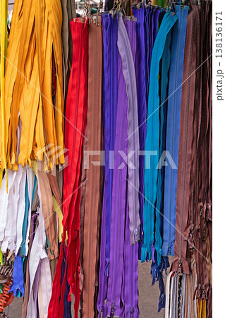 Colorful zippers sold on market stall 138136171