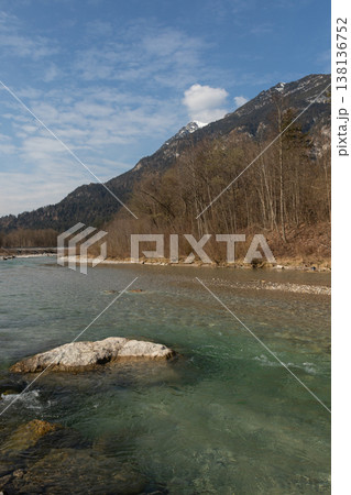 Clear Alpine River with Foreground Rock and Mountain Slope Clear Alpine River with Foreground Rock and Mountain Slope 138136752