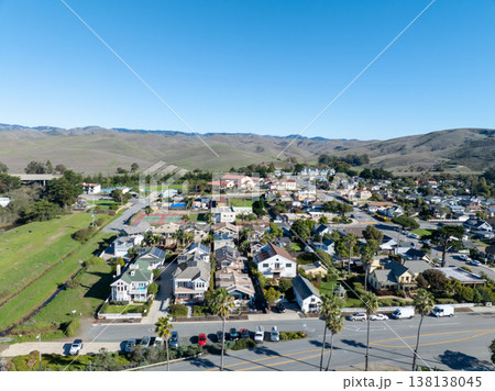 Aerial view of Cayucos, California USA, Pier, Ocean Ave and Shoreline Beach with Green Hills in San Luis Obispo County Aerial view of Cayucos, California USA, Pier, Ocean Ave and Shoreline Beach with Green Hills in San Luis Obispo County 138138045