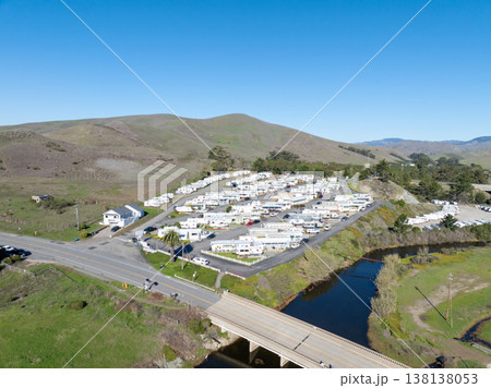Aerial view of Cayucos, California USA, Pier, Ocean Ave and Shoreline Beach with Green Hills in San Luis Obispo County 138138053