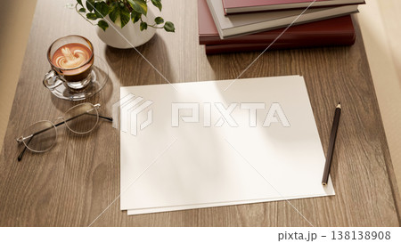 Close up of blank paper with pencil and eyeglasses aside coffee and book on wooden table in sunlight Close up of blank paper with pencil and eyeglasses aside coffee and book on wooden table in sunlight 138138908
