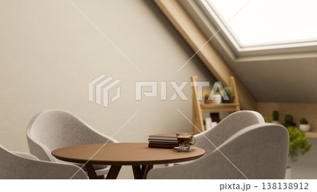 Coffee and books on round wooden table with curved chair and potted plants under attic roof window Coffee and books on round wooden table with curved chair and potted plants under attic roof window 138138912
