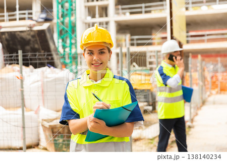 Girl engineer checking work process Girl engineer checking work process 138140234
