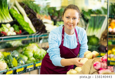 woman seller offers to buy onion woman seller offers to buy onion 138140443